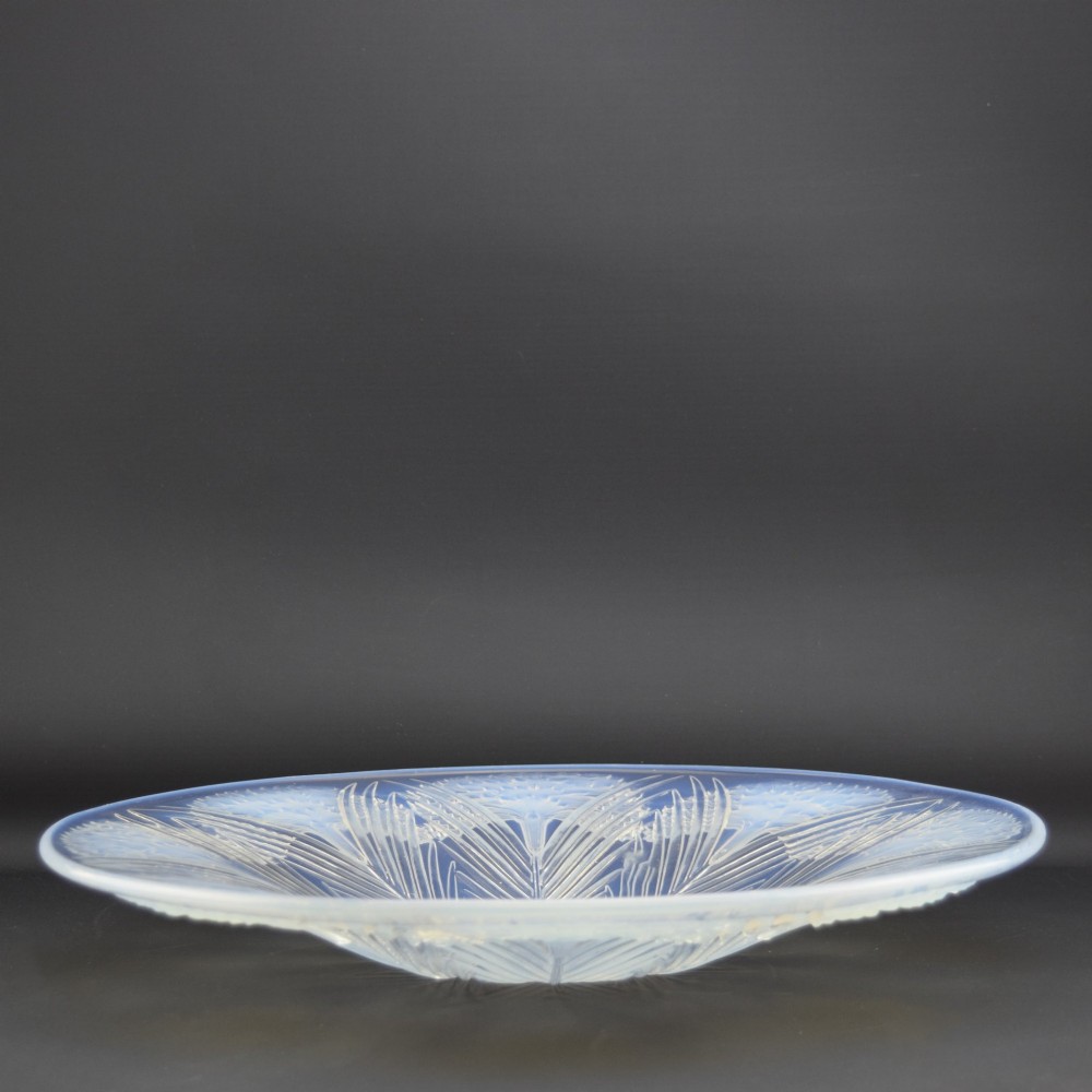 A circular Art Deco opalescent glass shallow bowl featuring a molded floral carnation design radiating from a central signature. View VI