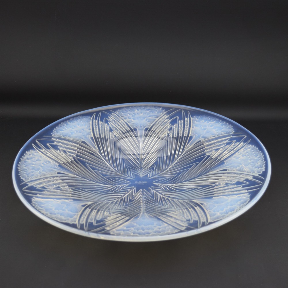 A circular Art Deco opalescent glass shallow bowl featuring a molded floral carnation design radiating from a central signature. View VII