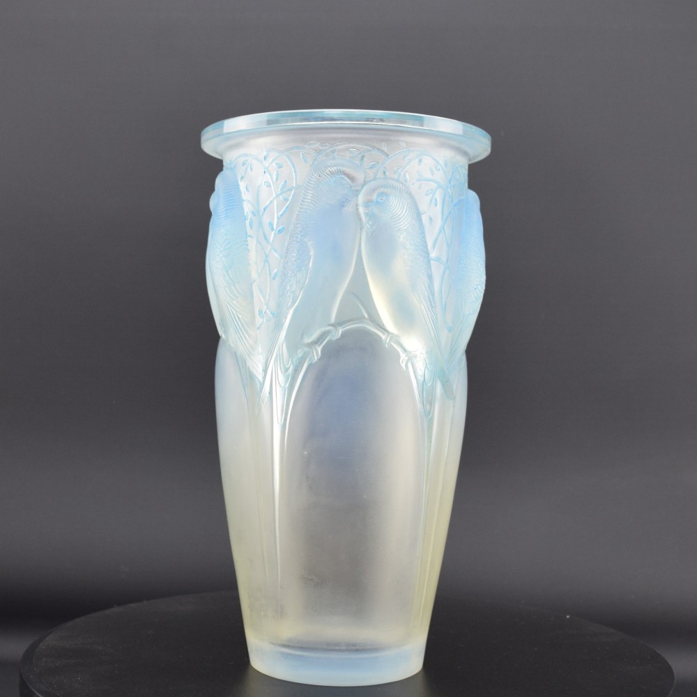 An Art Deco Rene Lalique opalescent glass vase featuring high relief carvings of budgerigars perched on branches with subtle blue staining. View II