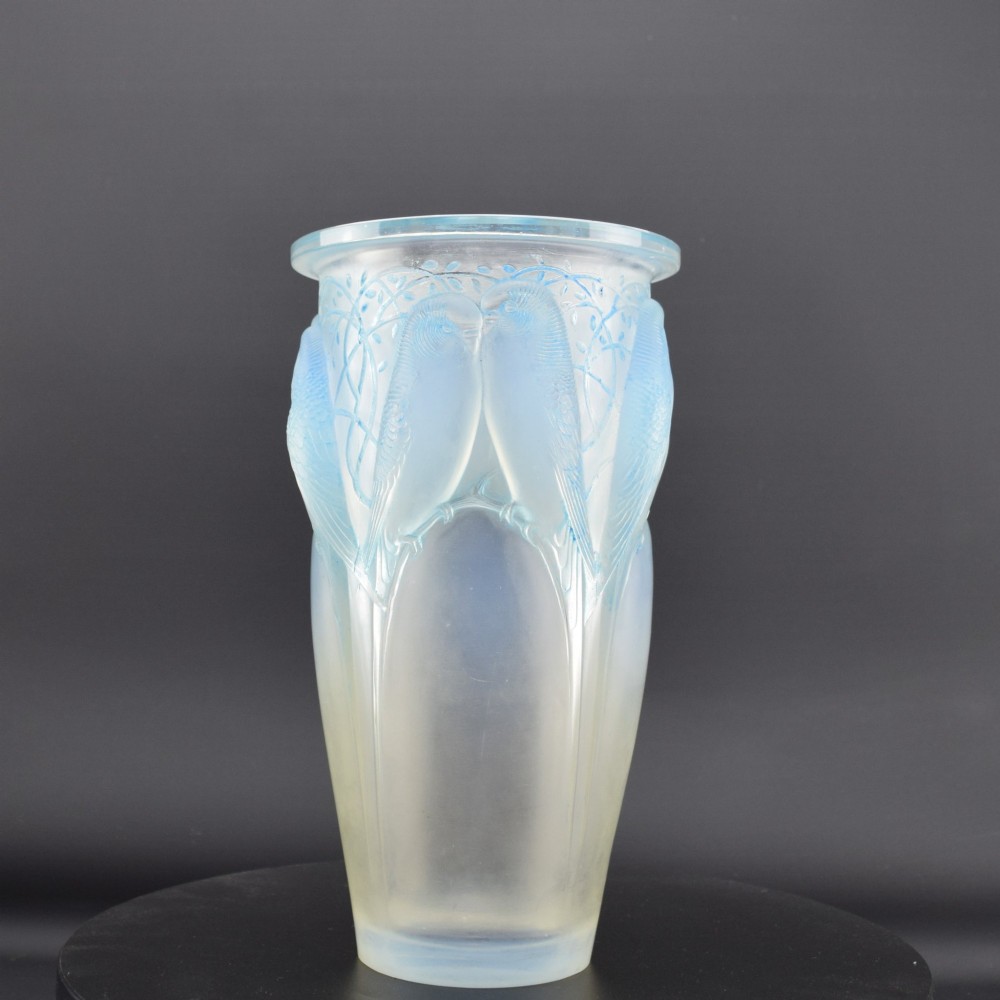 An Art Deco Rene Lalique opalescent glass vase featuring high relief carvings of budgerigars perched on branches with subtle blue staining. View III