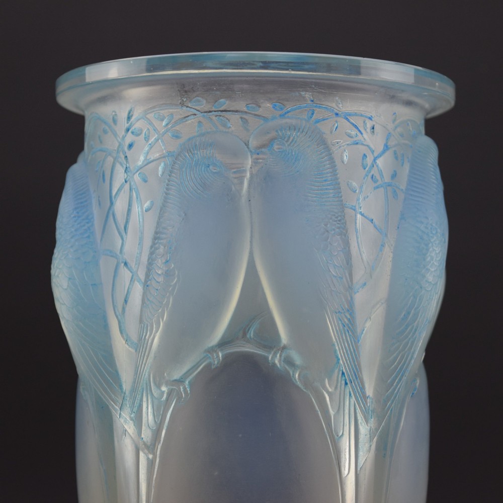 An Art Deco Rene Lalique opalescent glass vase featuring high relief carvings of budgerigars perched on branches with subtle blue staining. View IV