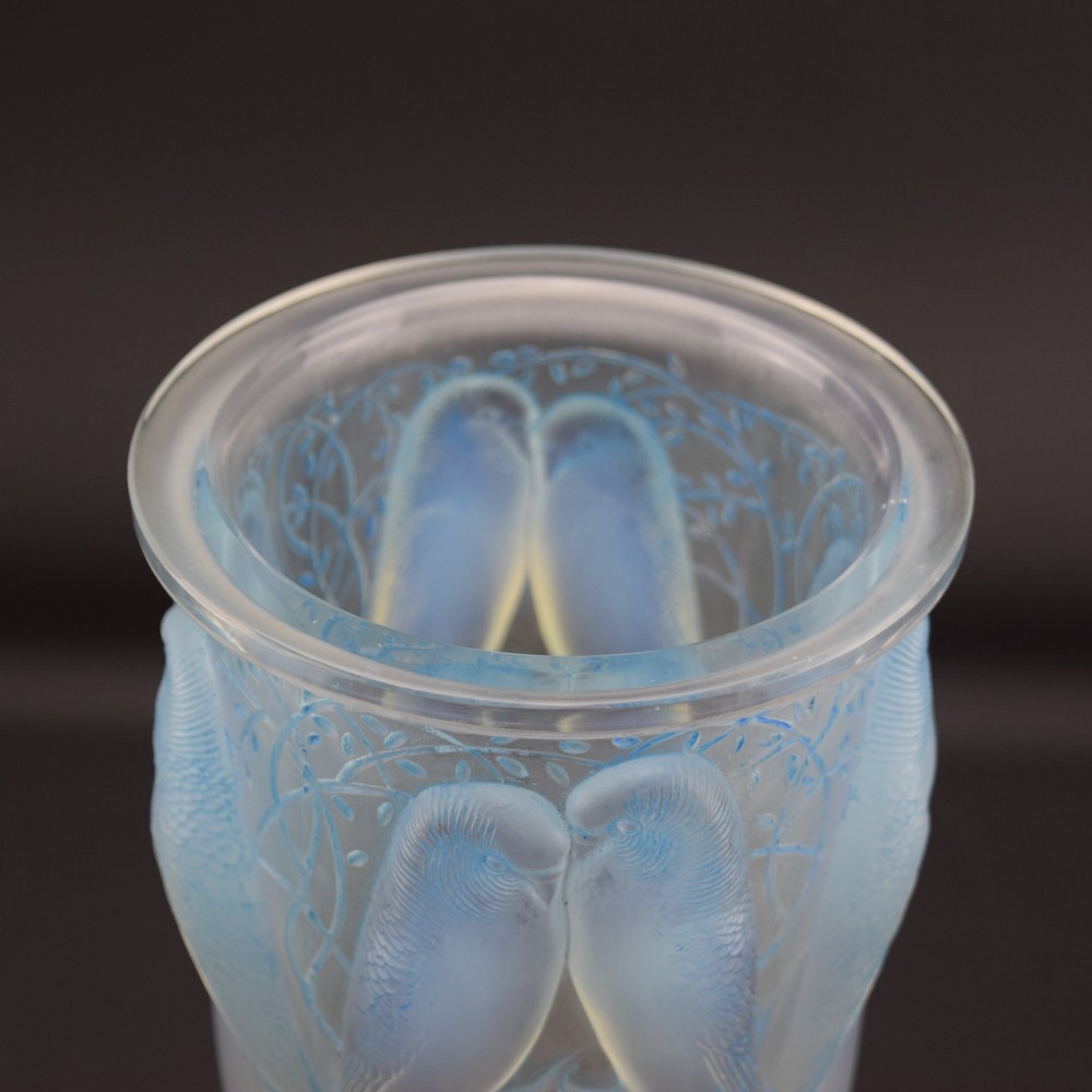An Art Deco Rene Lalique opalescent glass vase featuring high relief carvings of budgerigars perched on branches with subtle blue staining. View V