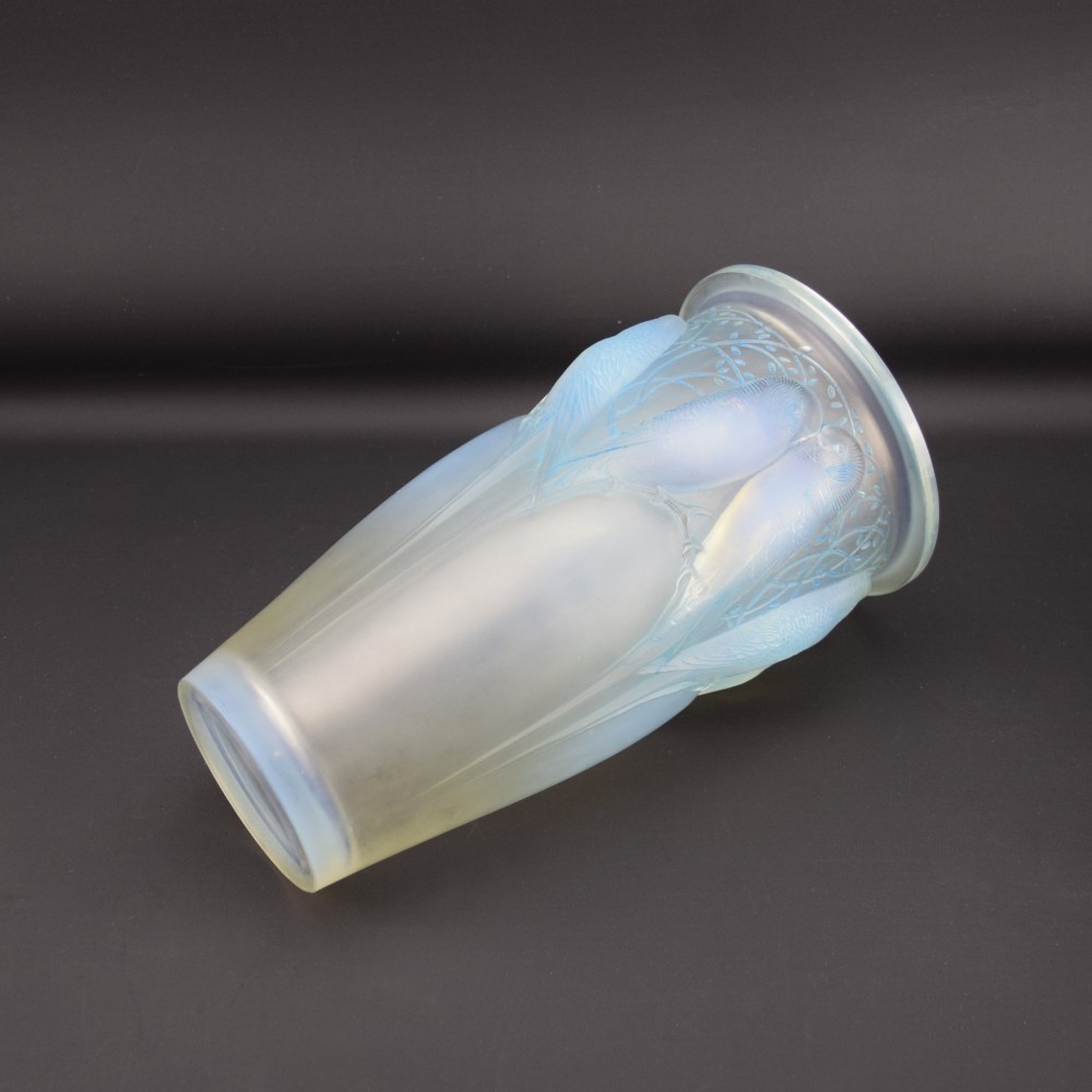 An Art Deco Rene Lalique opalescent glass vase featuring high relief carvings of budgerigars perched on branches with subtle blue staining. View VII