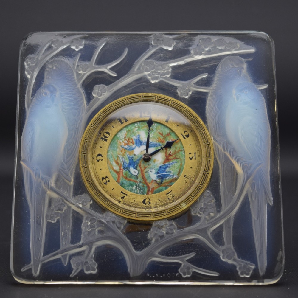 A square Rene Lalique Art Deco opalescent glass clock depicting moulded lovebirds amongst branches around a central circular brass dial. View II