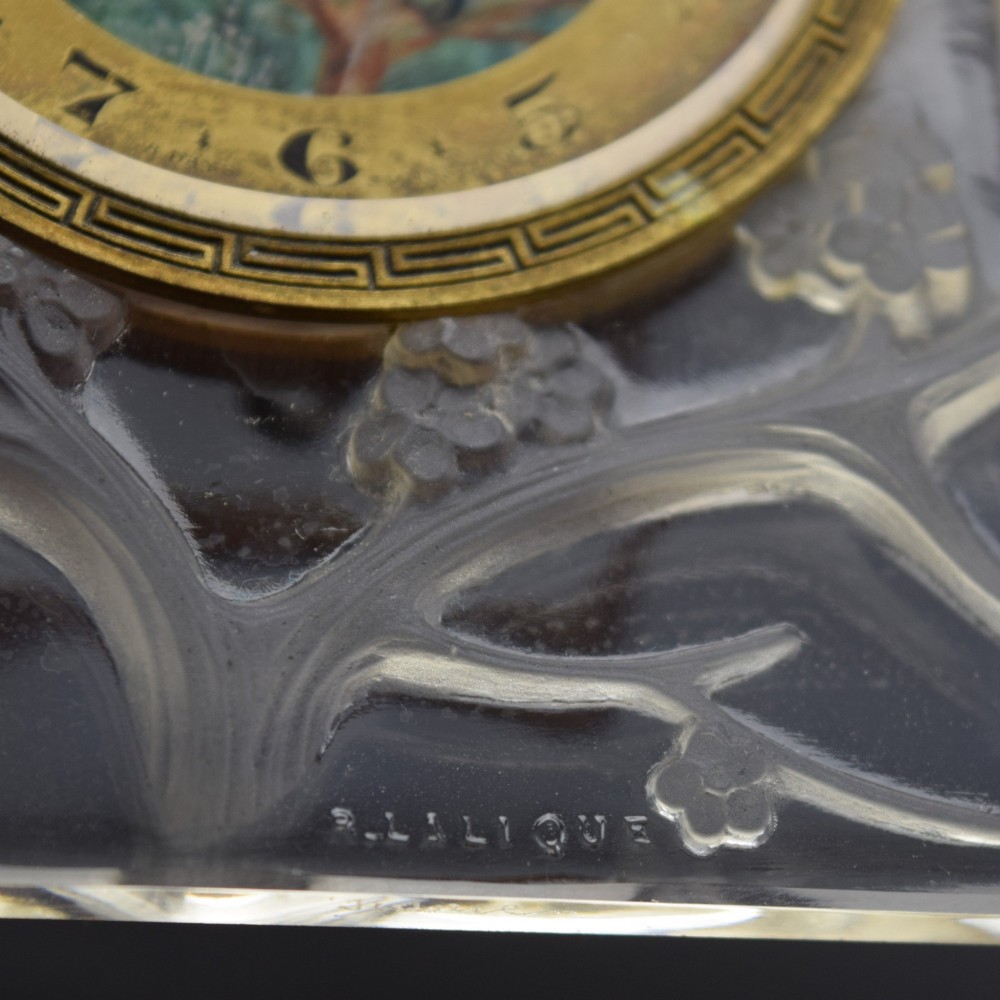 A square Rene Lalique Art Deco opalescent glass clock depicting moulded lovebirds amongst branches around a central circular brass dial. View IX