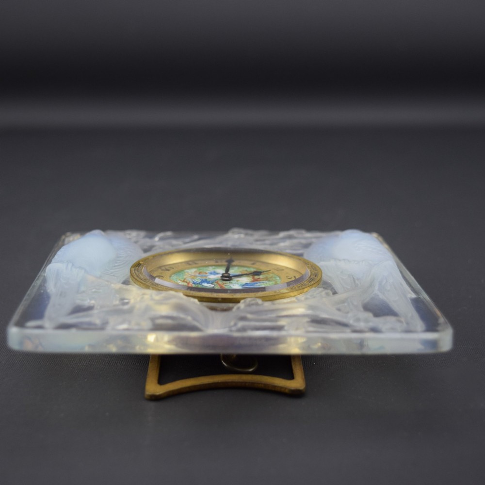 A square Rene Lalique Art Deco opalescent glass clock depicting moulded lovebirds amongst branches around a central circular brass dial. View X