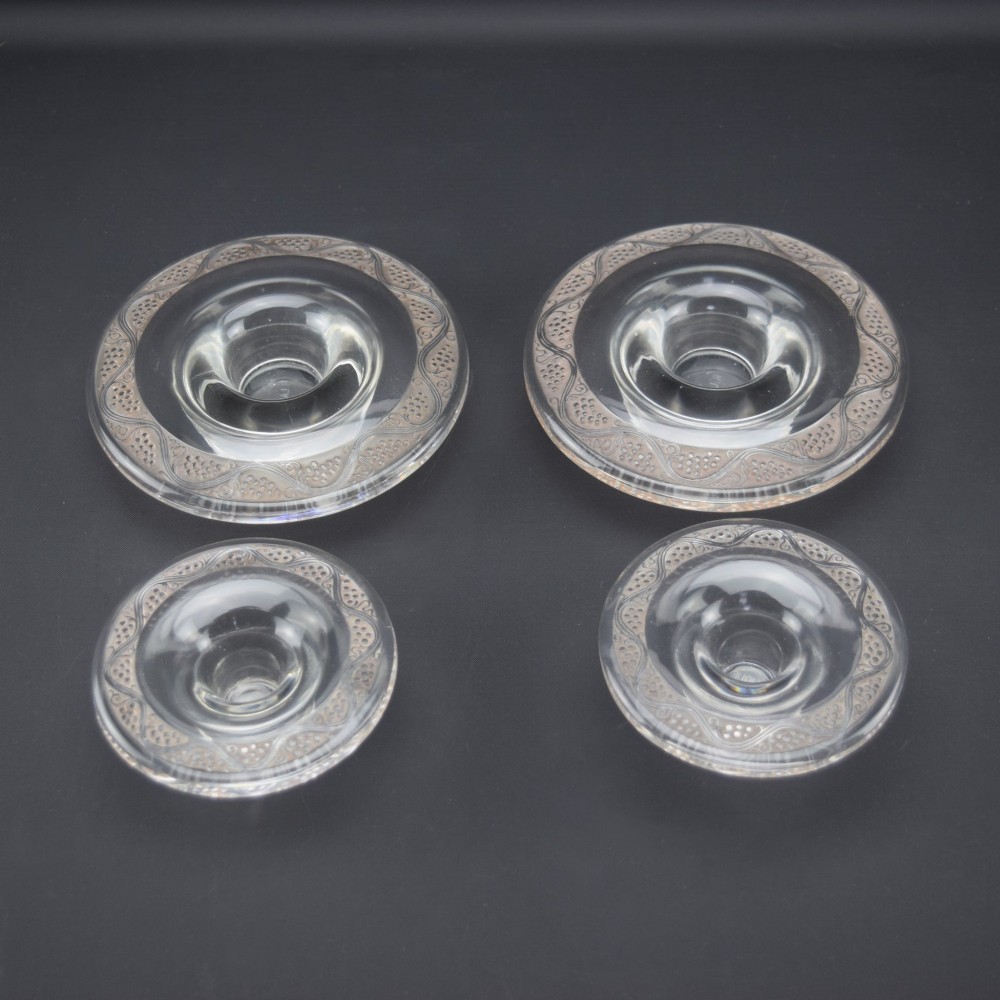 A pair of circular Rene Lalique clear glass Riquewihr candlesticks featuring concentric rings etched with a stylized grapevine motif. View II