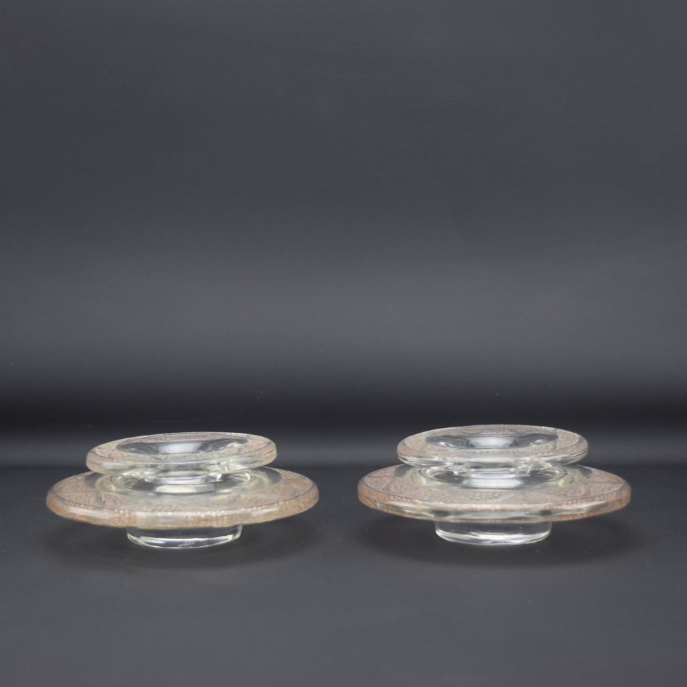 A pair of circular Rene Lalique clear glass Riquewihr candlesticks featuring concentric rings etched with a stylized grapevine motif. View III