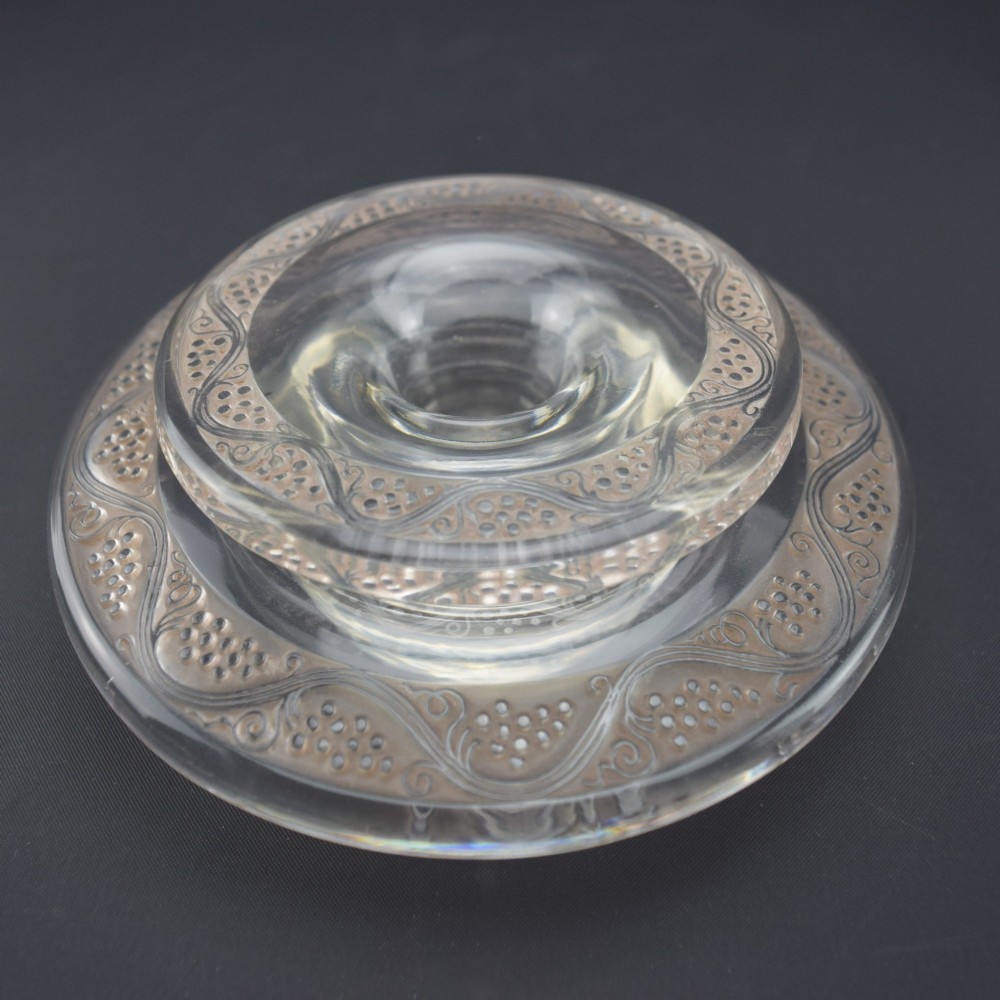 A pair of circular Rene Lalique clear glass Riquewihr candlesticks featuring concentric rings etched with a stylized grapevine motif. View IV
