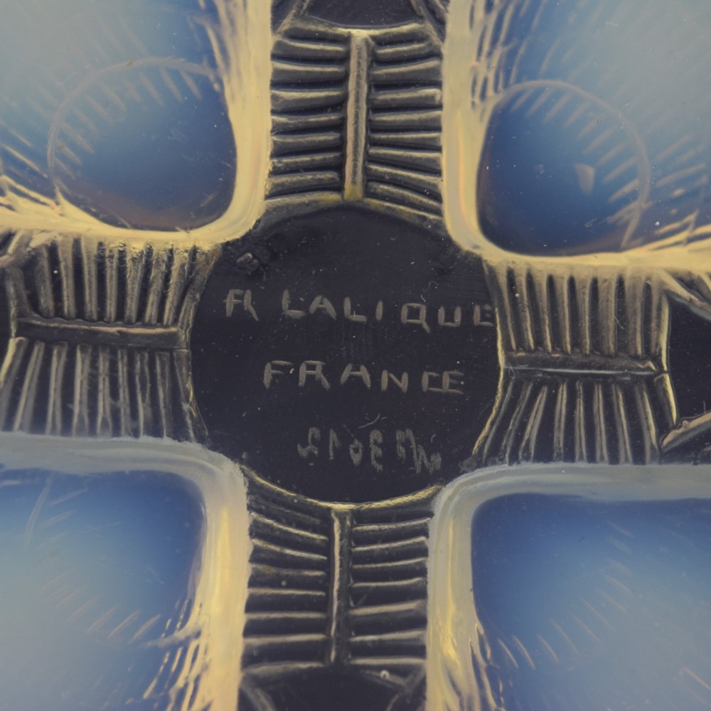 An Art Deco opalescent glass plate by Rene Lalique featuring a relief-moulded four-shell design with translucent blue highlights. View II