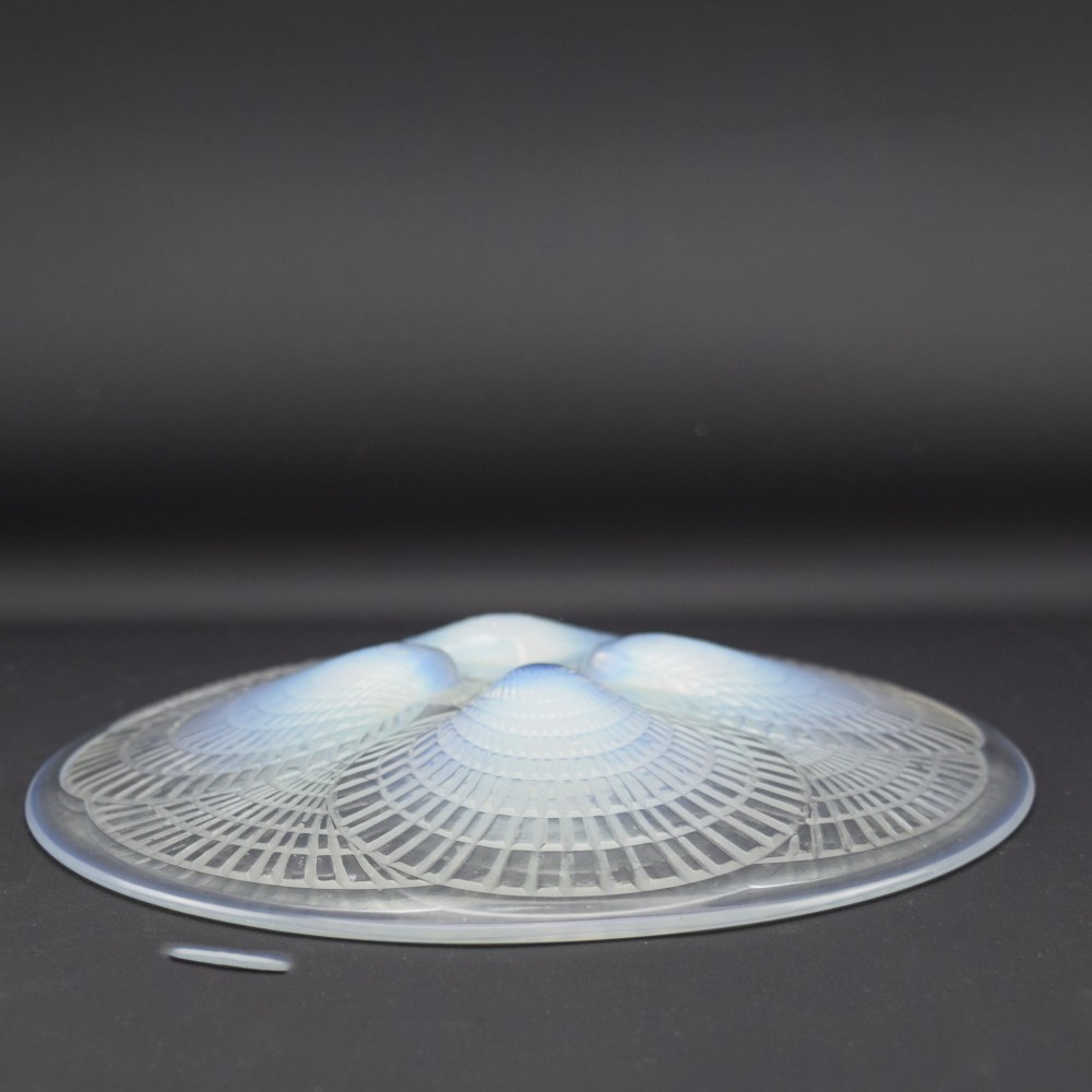 An Art Deco opalescent glass plate by Rene Lalique featuring a relief-moulded four-shell design with translucent blue highlights. View IV