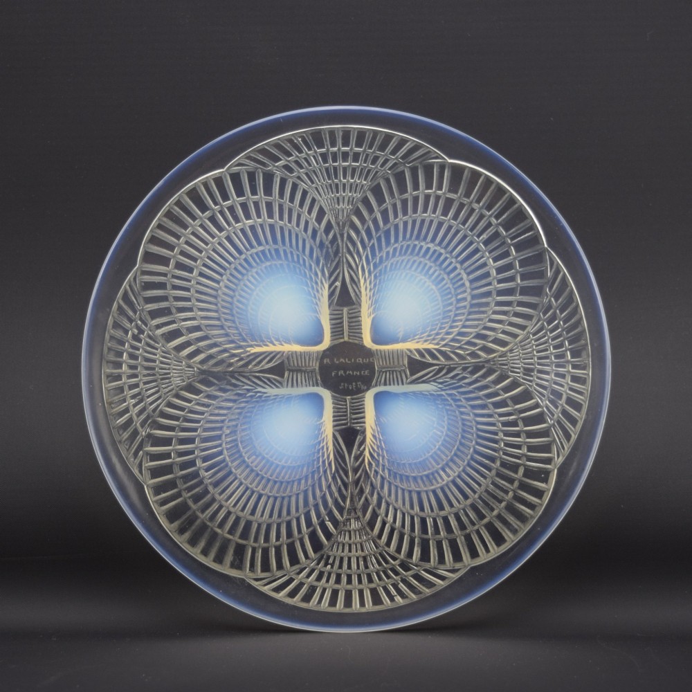 An Art Deco opalescent glass plate by Rene Lalique featuring a relief-moulded four-shell design with translucent blue highlights. View V