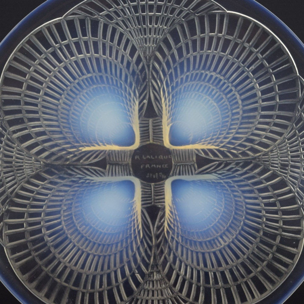 An Art Deco opalescent glass plate by Rene Lalique featuring a relief-moulded four-shell design with translucent blue highlights. View VI