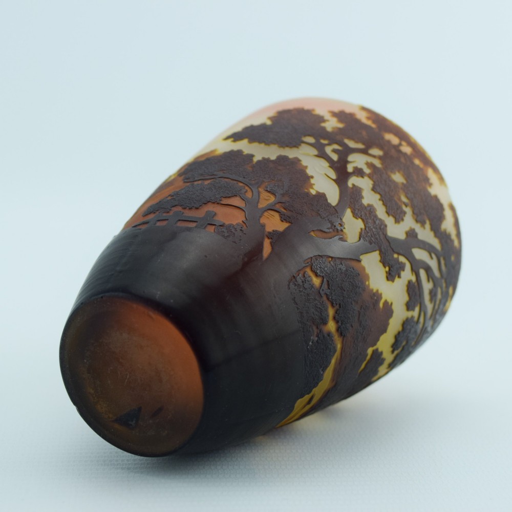 An Art Nouveau cameo glass vase featuring an acid-etched dark brown woodland landscape set against a warm yellow and soft pink background. View XI