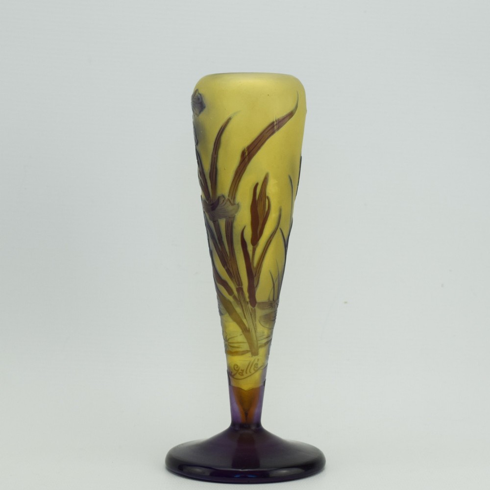 An Art Nouveau cameo glass vase featuring dark purple and brown acid-etched iris flowers against a textured yellow background with a dark purple foot. View IV