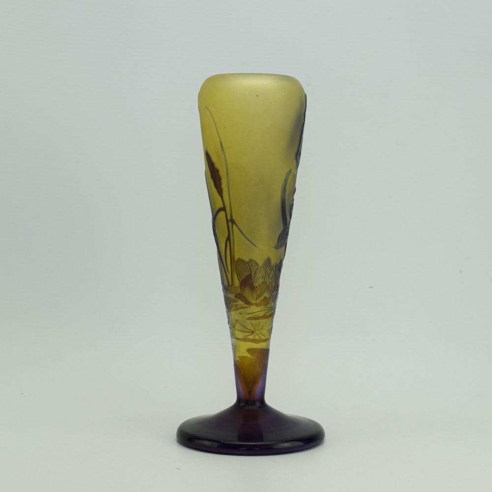 An Art Nouveau cameo glass vase featuring dark purple and brown acid-etched iris flowers against a textured yellow background with a dark purple foot. View VI