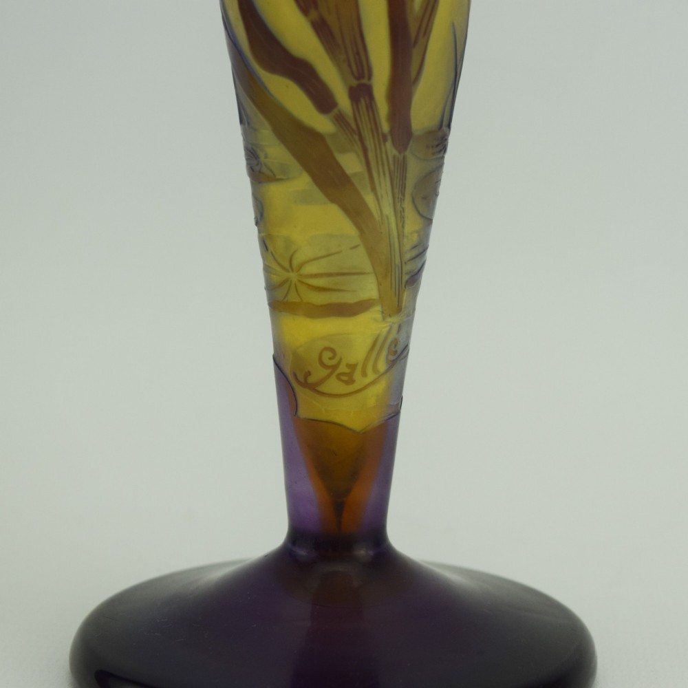 An Art Nouveau cameo glass vase featuring dark purple and brown acid-etched iris flowers against a textured yellow background with a dark purple foot. View VIII