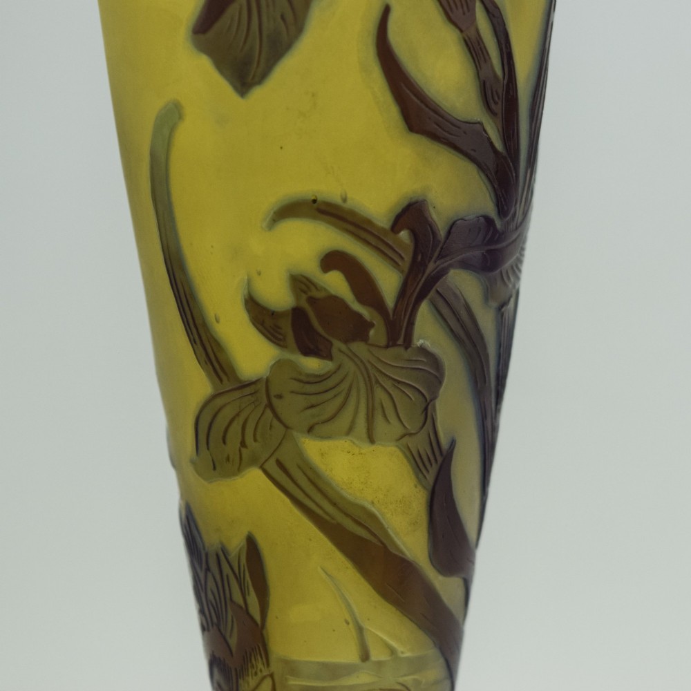 An Art Nouveau cameo glass vase featuring dark purple and brown acid-etched iris flowers against a textured yellow background with a dark purple foot. View XII