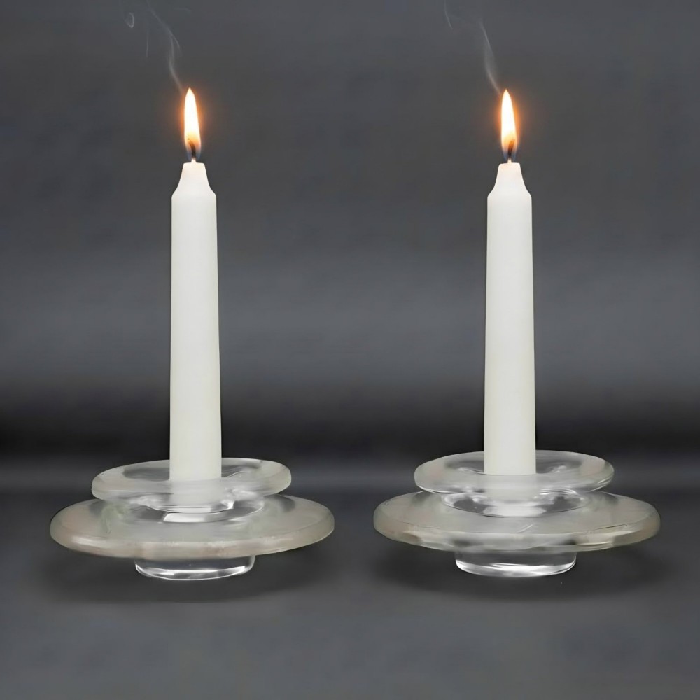 A pair of circular Rene Lalique clear glass Riquewihr candlesticks featuring concentric rings etched with a stylized grapevine motif. View VII