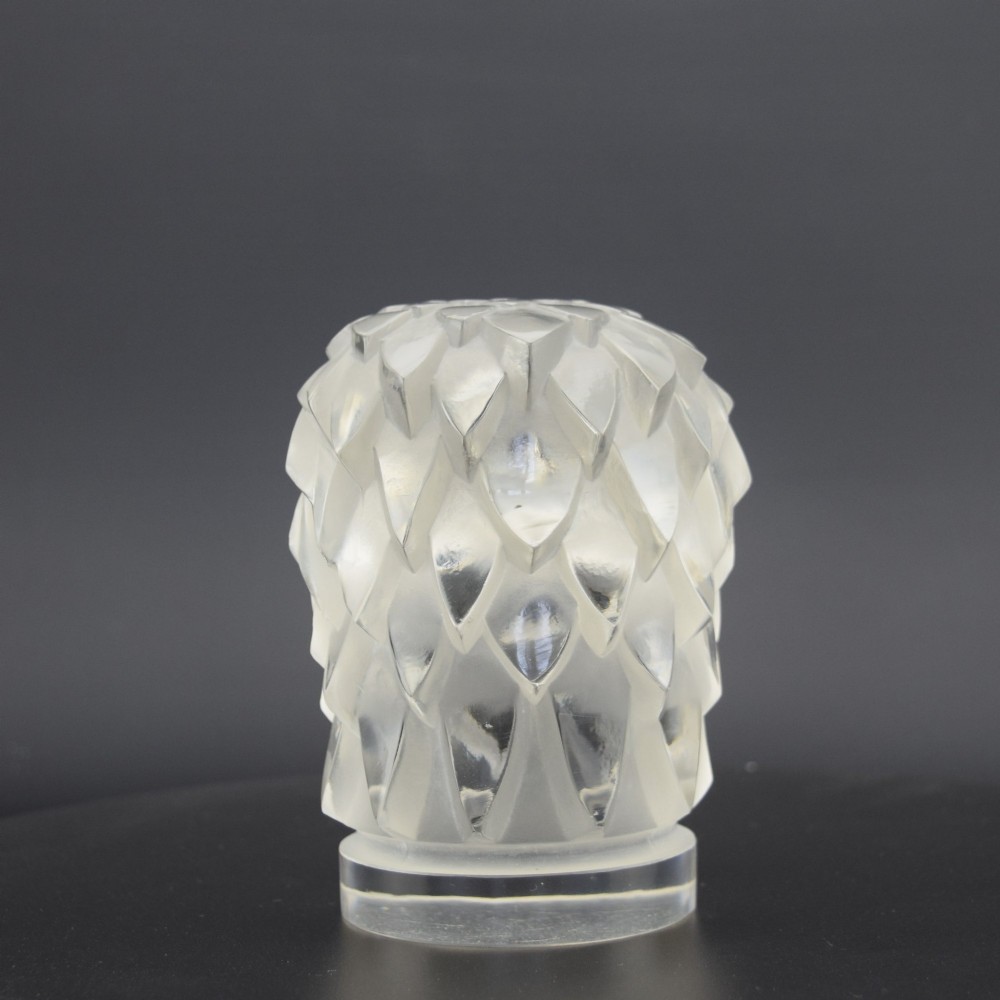 A clear and frosted moulded glass sculpture depicting an eagle head in profile, designed as an Art Deco automobile mascot. View IV