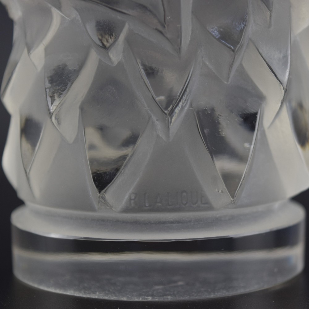 A clear and frosted moulded glass sculpture depicting an eagle head in profile, designed as an Art Deco automobile mascot. View VIII