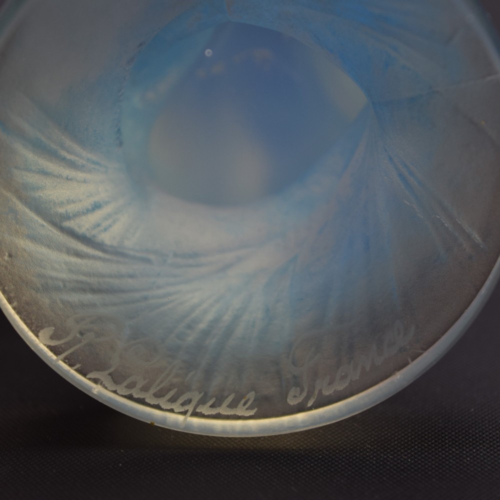 An Art Deco opalescent blue glass car mascot depicting a Sirene or mermaid-like crouching figure on a circular base. View X