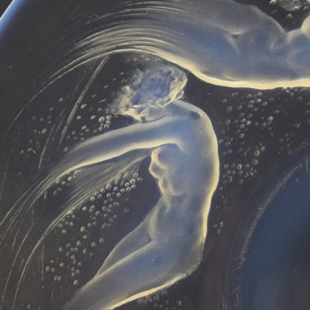 A circular Lalique opalescent glass plate featuring a central motif of six relief-moulded swimming water nymphs. View IV
