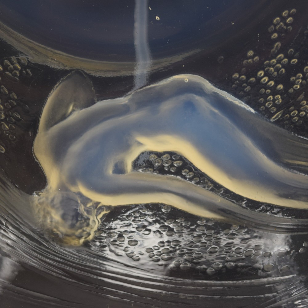 A circular Lalique opalescent glass plate featuring a central motif of six relief-moulded swimming water nymphs. View V
