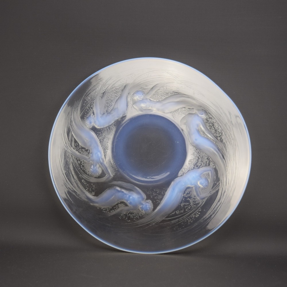 A circular Lalique opalescent glass plate featuring a central motif of six relief-moulded swimming water nymphs. View VII