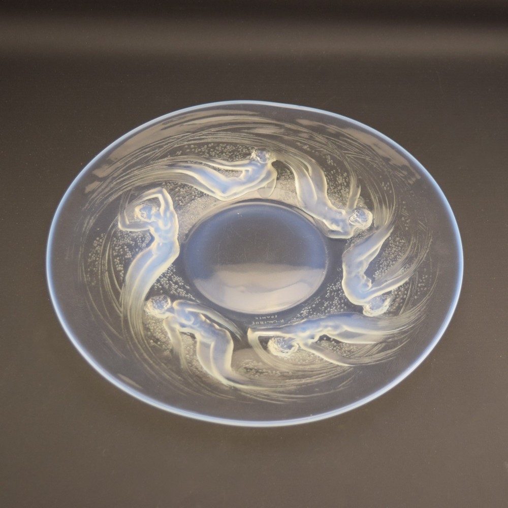 A circular Lalique opalescent glass plate featuring a central motif of six relief-moulded swimming water nymphs. View VIII