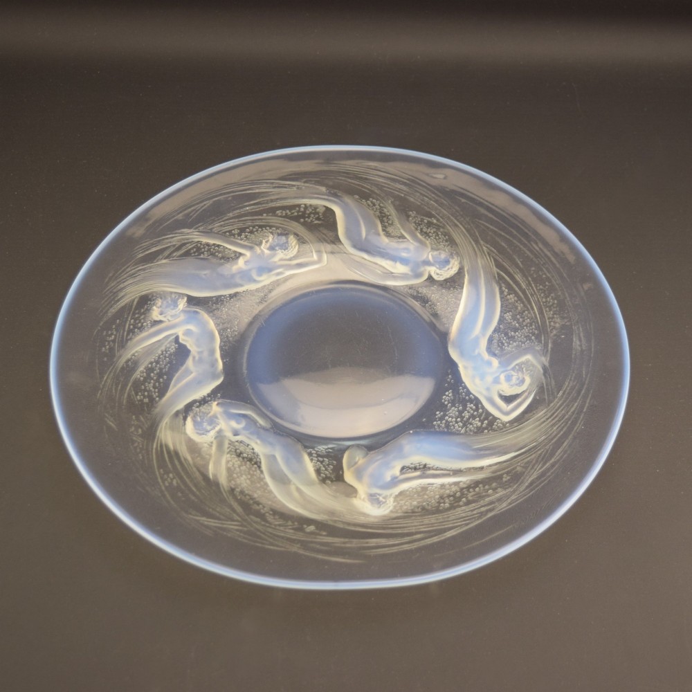 A circular Lalique opalescent glass plate featuring a central motif of six relief-moulded swimming water nymphs. View IX