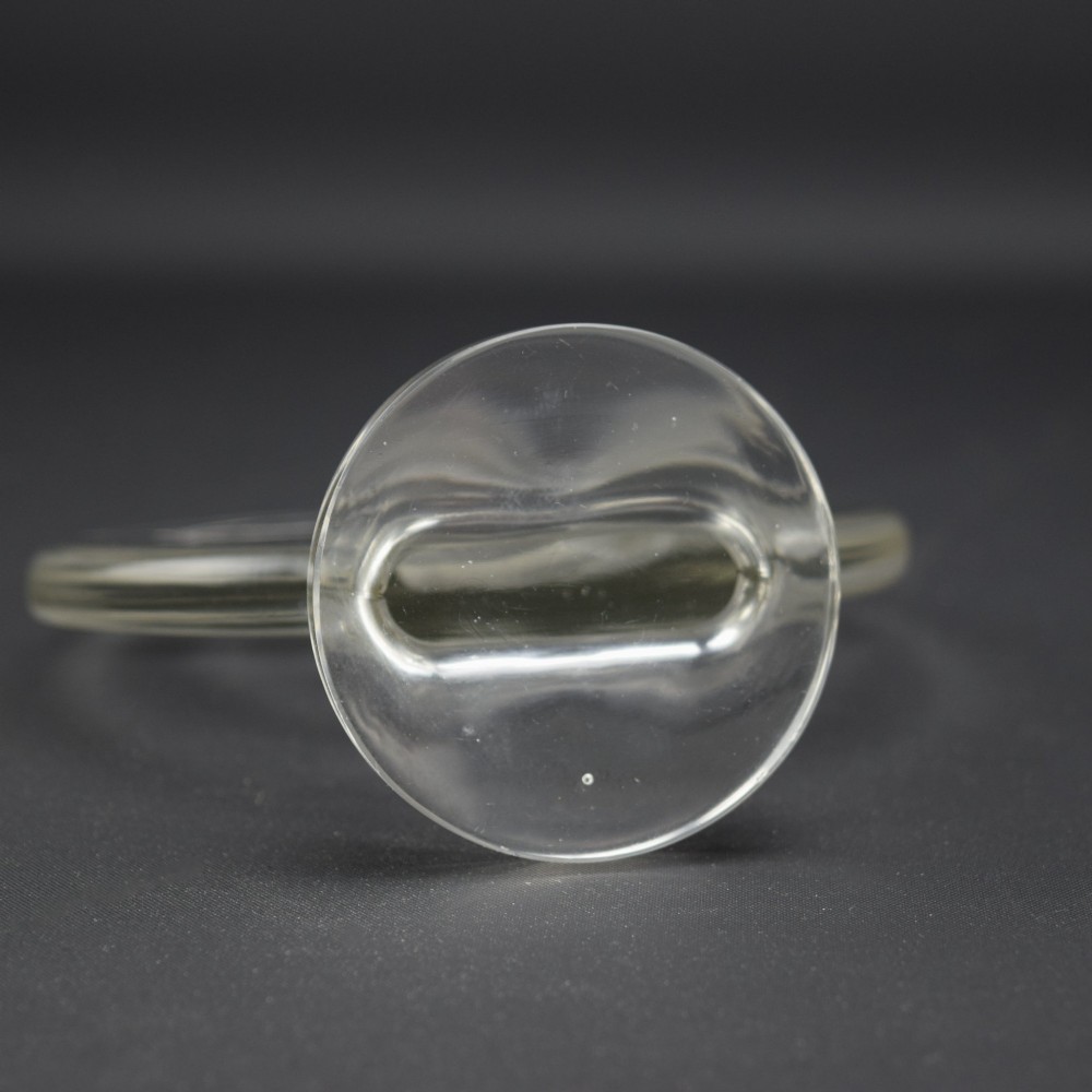 A circular clear and frosted Art Deco glass car mascot by Rene Lalique featuring a relief carving of a kneeling archer drawing a bow. View VI