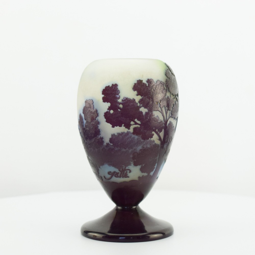 An Art Nouveau cameo glass footed vase depicting a dark purple tree landscape against a frosted green and white background. View II