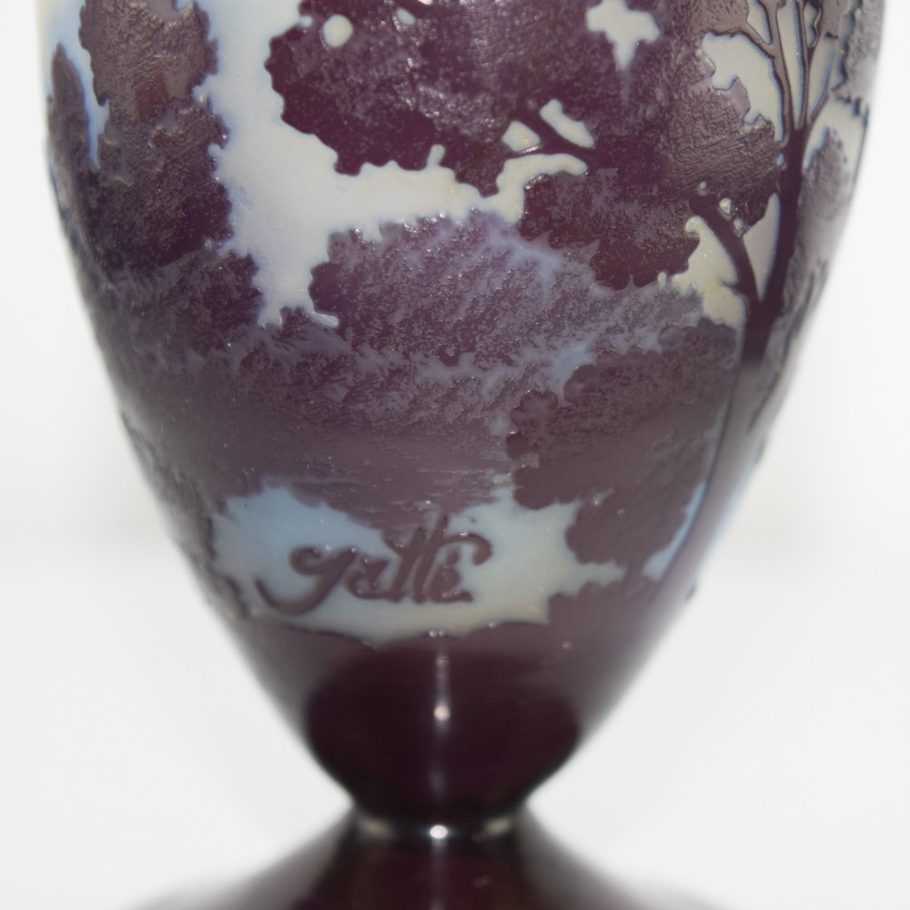 An Art Nouveau cameo glass footed vase depicting a dark purple tree landscape against a frosted green and white background. View V