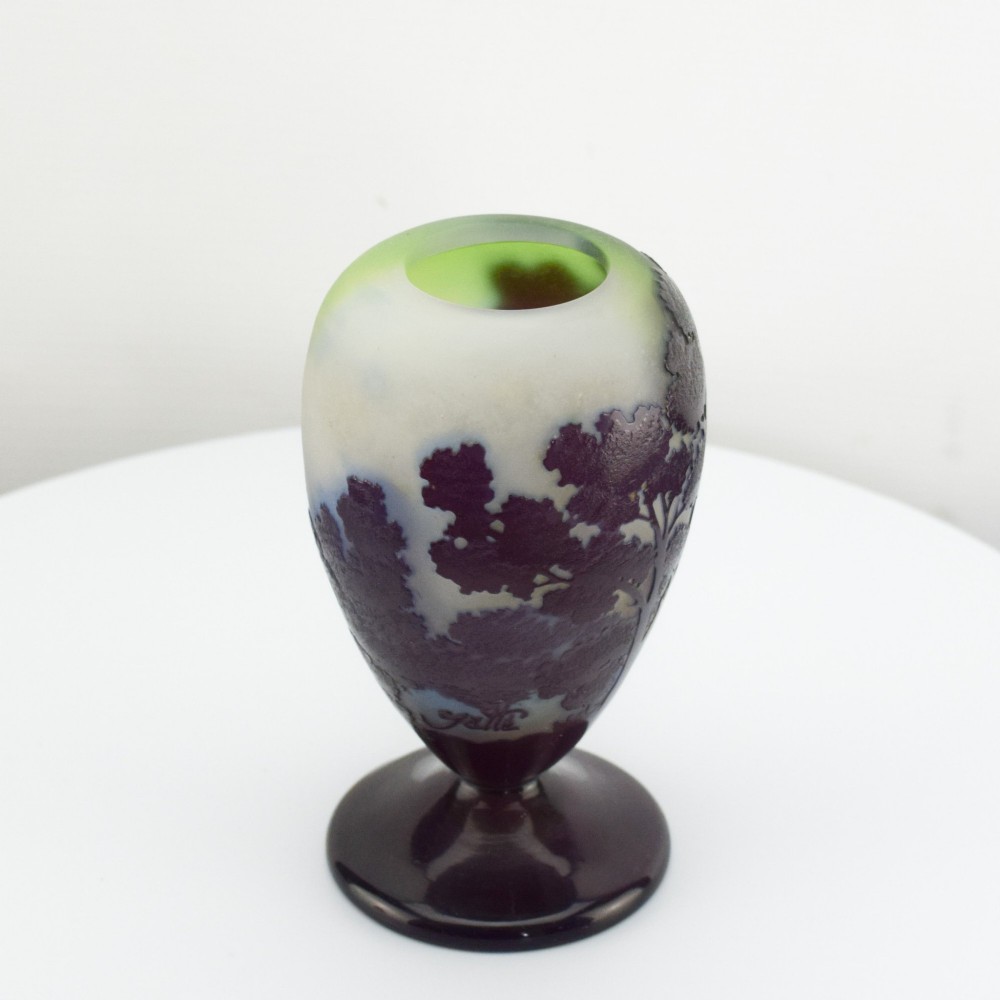 An Art Nouveau cameo glass footed vase depicting a dark purple tree landscape against a frosted green and white background. View VII