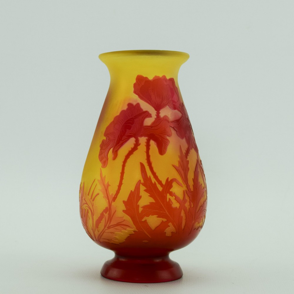 An Art Nouveau French cameo glass footed vase featuring an acid-etched red poppy design over a translucent yellow and orange ground. View V