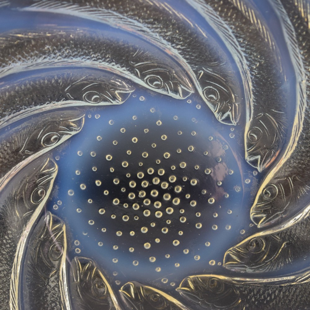 A circular Art Deco opalescent blue glass shallow bowl decorated with a spiralling pattern of moulded fish and a central field of small raised bubbles. View V