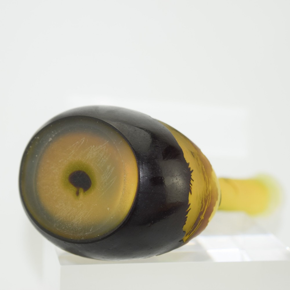 A yellow and dark brown Art Nouveau cameo glass vase featuring an acid-etched forest landscape with trees and birds on a long slender neck. View VII
