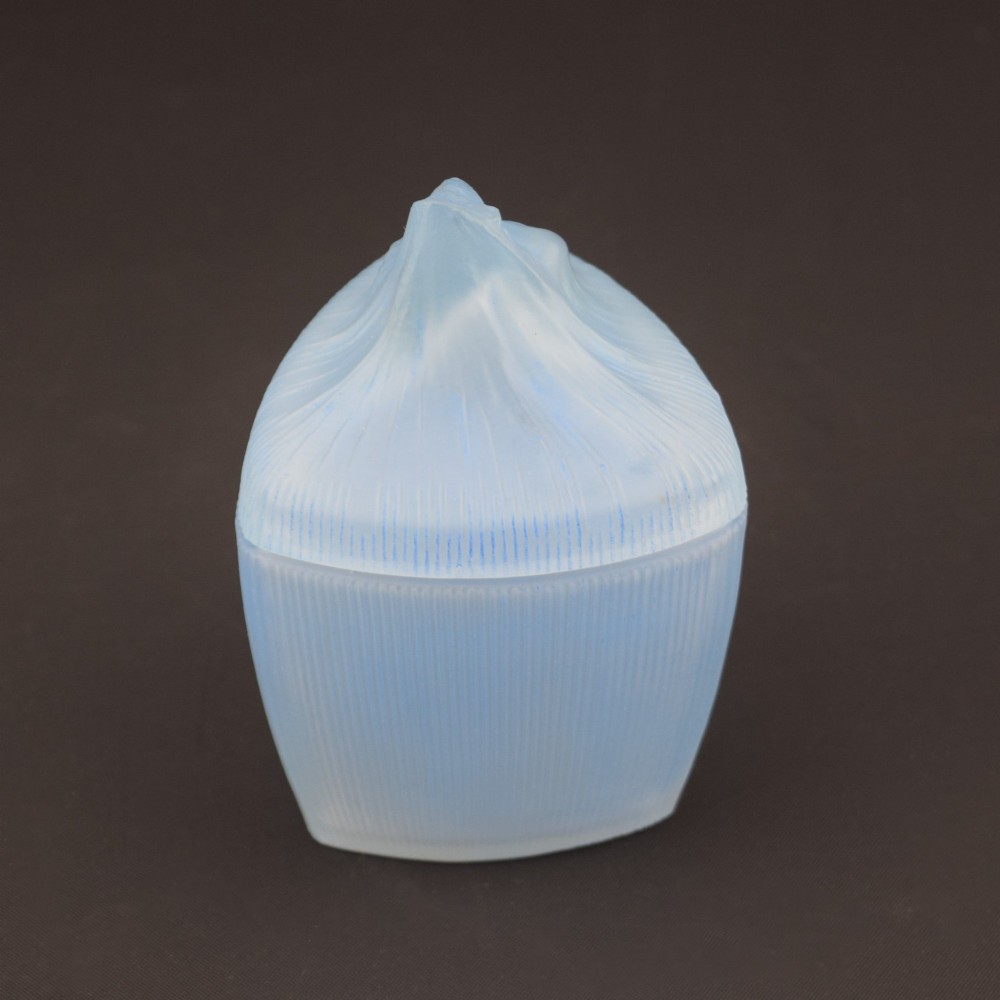 An opalescent blue glass powder box designed by Rene Lalique featuring a moulded female head with flowing drapery on the lid and vertical ribbed sides. View III