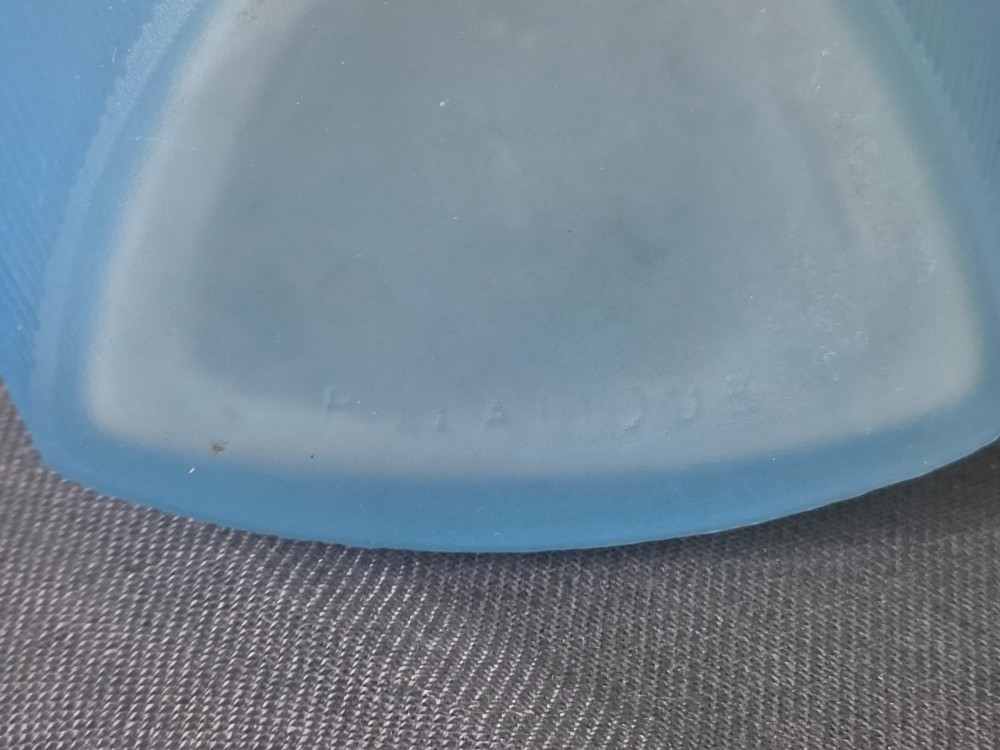 An opalescent blue glass powder box designed by Rene Lalique featuring a moulded female head with flowing drapery on the lid and vertical ribbed sides. View V