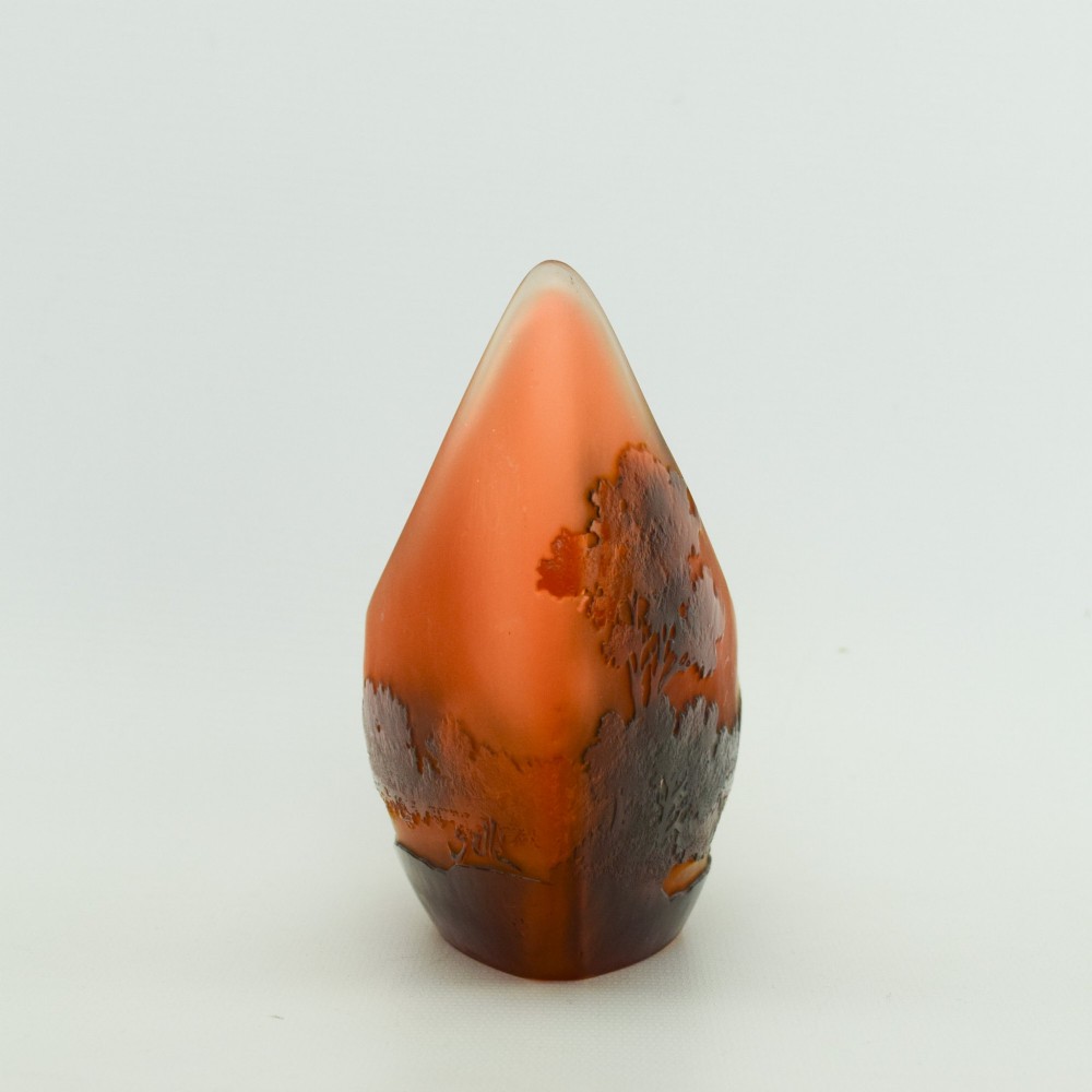 A crescent-shaped Art Nouveau cameo glass vase featuring an acid-etched river landscape in shades of burnt orange and dark brown against a frosted background. View VI
