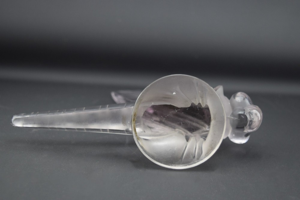 An Art Deco clear and frosted glass car mascot sculpted in the form of a stylised dragonfly with upright wings resting on a circular base. View XII
