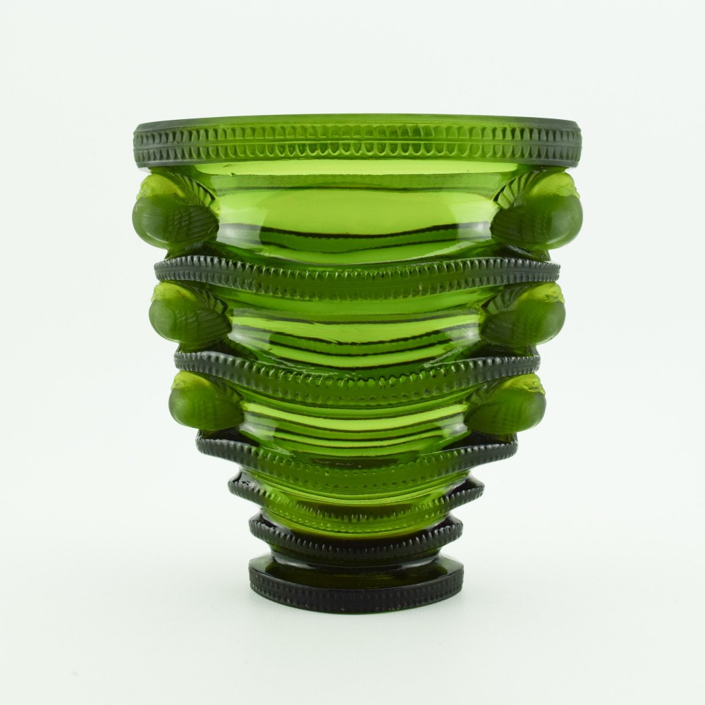 An olive green moulded glass vase with tiered horizontal ridging and frosted bird motifs descending the tapered sides. View V