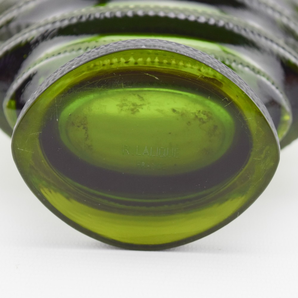 An olive green moulded glass vase with tiered horizontal ridging and frosted bird motifs descending the tapered sides. View VII