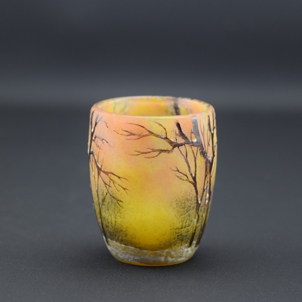 A small barrel-shaped frosted glass vase featuring an enamelled winter landscape with bare trees against a yellow and orange sky. View II