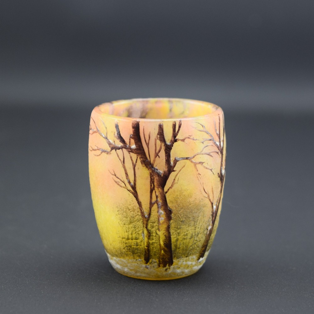 A small barrel-shaped frosted glass vase featuring an enamelled winter landscape with bare trees against a yellow and orange sky. View III