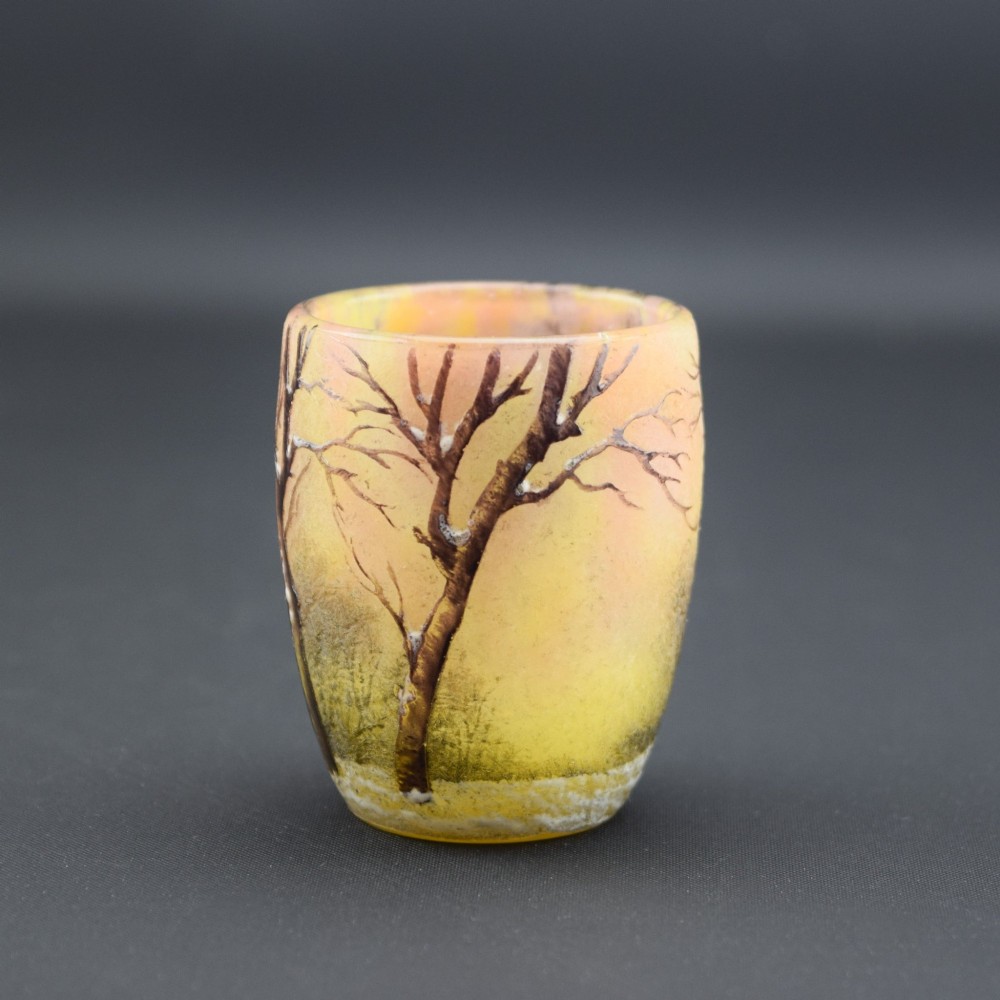 A small barrel-shaped frosted glass vase featuring an enamelled winter landscape with bare trees against a yellow and orange sky. View IV