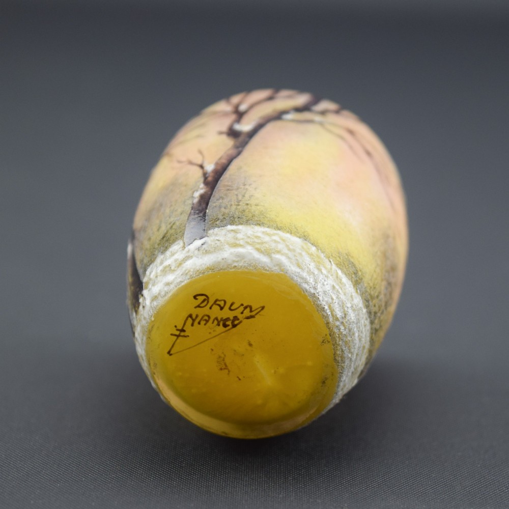 A small barrel-shaped frosted glass vase featuring an enamelled winter landscape with bare trees against a yellow and orange sky. View VI