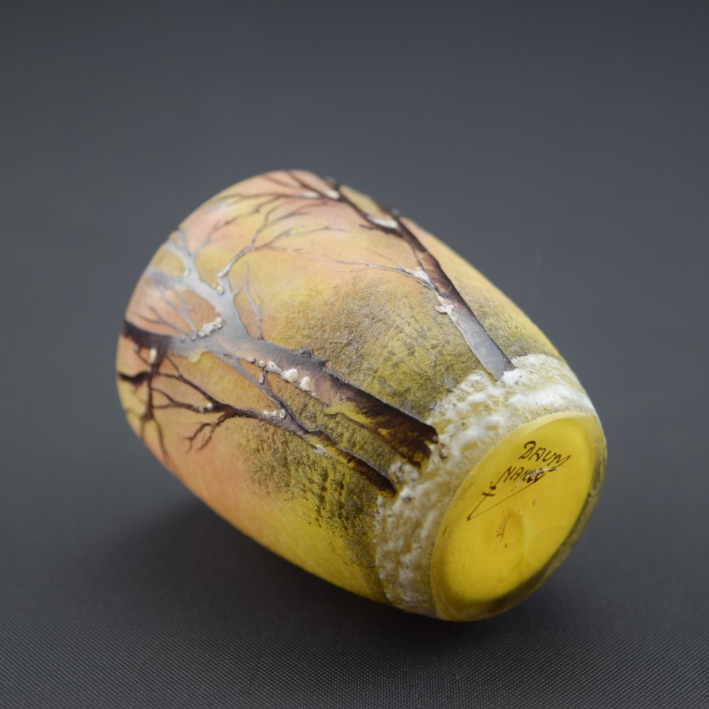 A small barrel-shaped frosted glass vase featuring an enamelled winter landscape with bare trees against a yellow and orange sky. View VII
