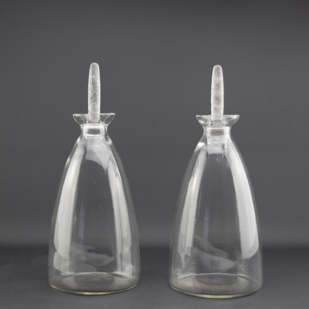 A pair of clear glass Art Deco conical decanters featuring elongated frosted glass stoppers with delicate leaf motifs. View III